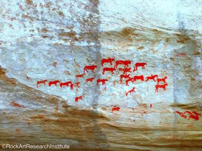 Rock art: red painted animals against grey rock